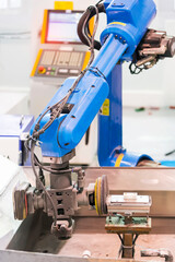 robot arm polishing the mobile phone part in the production line.