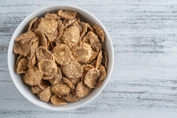 Whole grain glazed flakes in plate. Healthy breakfast, whole grain muesli in a bowl