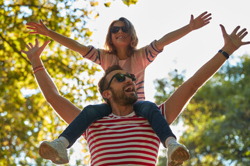 Single father and little daughter enjoying in the park.