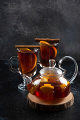 Two glass cups with hot tea and cinnamon sticks