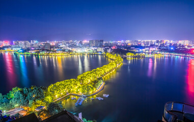 Night view: Overlooking the skyline of a city in southern China surrounded by mountains and rivers....