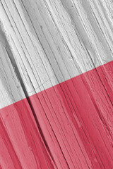 The flag of Poland on dry wooden surface, cracked with age. Vertical background, wallpaper or...