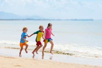 Kids playing on beach. Children play at sea.