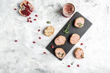 Fresh homemade chicken liver pate on toasted bread with greens and pomegranate. Chicken liver pate spread. banner, menu recipe place for text, top view