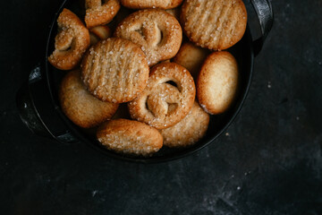 cookies in a metal plate on a dark background