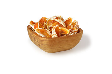 Slices of dried tangerines in wooden bowl isolated on white