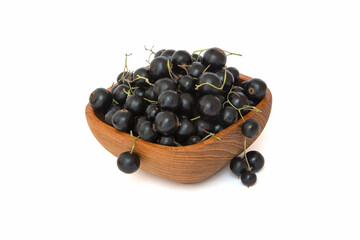 Black currant in woody bowl isolated on a white