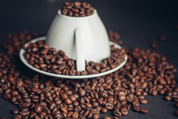 coffee grain on inverted mug and saucer on gray Arabica table