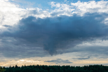 Before the rain. Thundercloud over an agricultural field on a summer evening