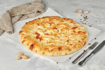 Ossetian pie with chicken and mushrooms on light background