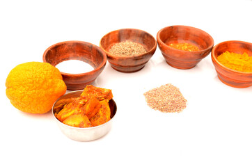 the grape fruit pickle with turmeric powder,cuisine,salt,chilly powder,cumin, on the white background.