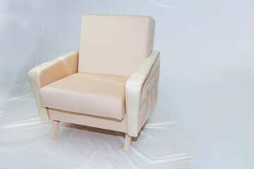 Vintage furniture: reclining chair made of fabric, on a light background.