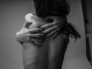 Woman black and white photography portrait rear view touching back with hands