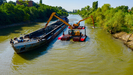 Fototapeta na wymiar Aerial view of river, canal is being dredged by excavators