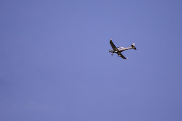 small plane with propellers flying in the blue sky. means of air transport