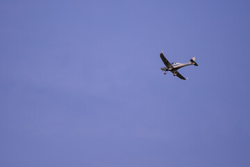 small plane with propellers flying in the blue sky. means of air transport