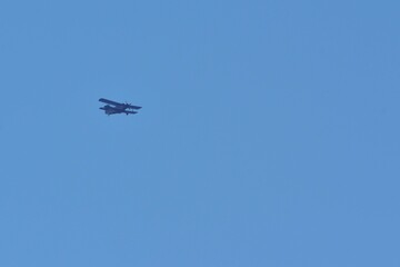 small plane with propellers flying in the blue sky. means of air transport