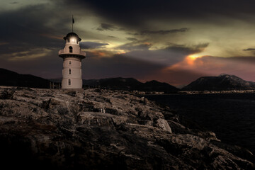 Fototapeta na wymiar Lighthouse on a mediterranean coast at night.