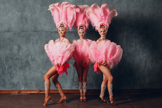 Three Women in cabaret costume with pink feathers plumage