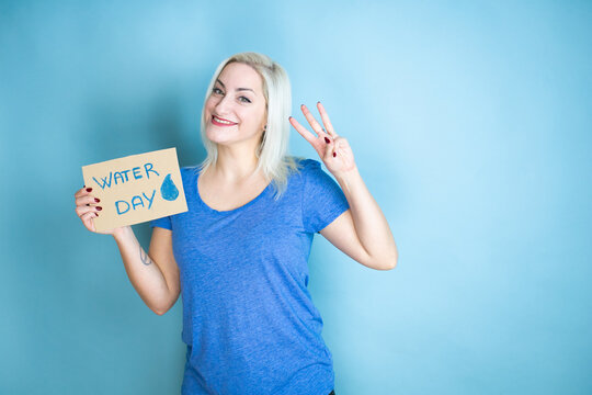 Young Beautiful Woman Asking For The Environment Holding Banner With Water Day Message Showing And Pointing Up With Fingers Number Three While Smiling Confident And Happy