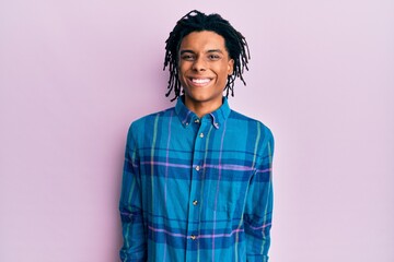 Young african american man wearing casual clothes looking positive and happy standing and smiling with a confident smile showing teeth