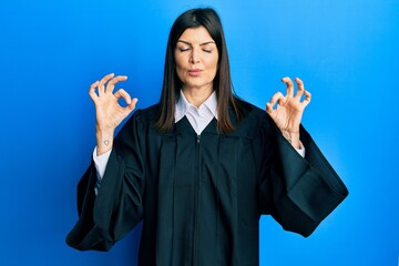 Young hispanic woman wearing judge uniform relax and smiling with eyes closed doing meditation...