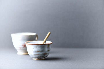 Traditional, handcrafted ceramic on gray background. Soft focus. Copy space.	