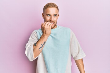 Young caucasian man wearing casual clothes looking stressed and nervous with hands on mouth biting...