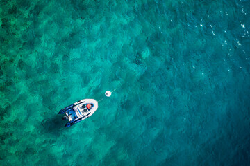 Top view of  turquoise water and boat.