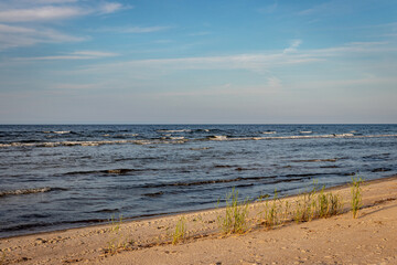 beautiful miraculous seascape without people, Baltic sea Riga gulf, waves in evening sunset