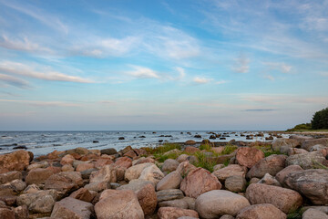 blue evening evening sun , sunset over sea, rocky sea shore, Baltic sea, Riga gulf
