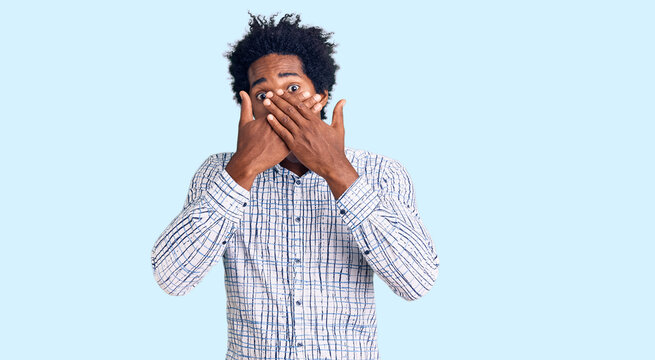 Handsome african american man with afro hair wearing casual clothes shocked covering mouth with hands for mistake. secret concept.