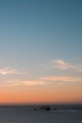 ship in the middle of the sea in a sunset