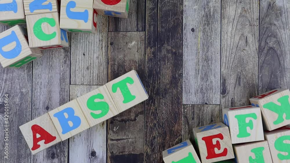 Poster colourful alphabet letters on wooden cubes with word - abstract - in a diagonal line with additional