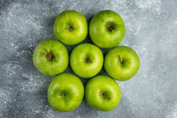A lot of ripe apples on marble surface