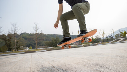 Asian woman skateboarder skateboarding in modern city