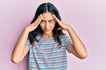 Hispanic teenager girl with dental braces wearing casual clothes with hand on head for pain in head because stress. suffering migraine.