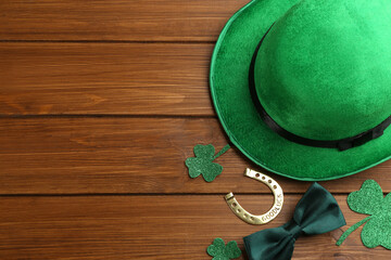 Flat lay composition with leprechaun hat on wooden table, space for text. St Patrick's Day...