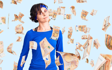 Beautiful young woman with short hair wearing training workout clothes looking sleepy and tired, exhausted for fatigue and hangover, lazy eyes in the morning.