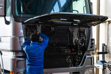 Mechanic repairing the truck in the garage