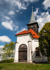 Fototapeta na wymiar old white church with wooden door and clock tower 