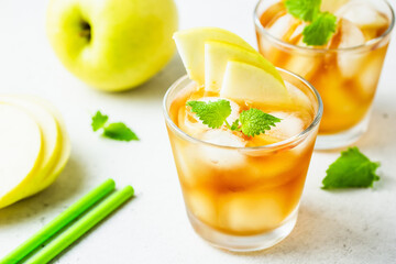 Kombucha cocktail, summer festive party drink, apple iced tea in glasses. Space for text.