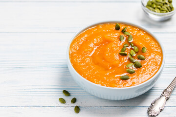 Vegan curried pumpkin lentil soup puree in a bowl. Space for text.