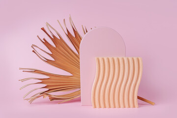 Arch, wooden plate with waves  with dry tropical leaf on a pink background.  Natural and manmade...