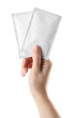 Woman holding medicine sachets on white background, closeup