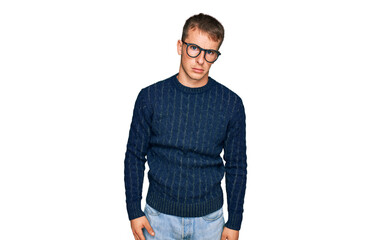 Young blond man wearing casual clothes and glasses skeptic and nervous, frowning upset because of...