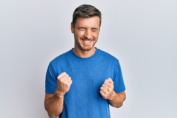 Handsome caucasian man wearing casual clothes celebrating surprised and amazed for success with arms raised and eyes closed