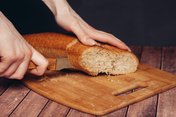slicing a fresh loaf on a cutting board kitchen meal