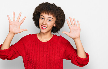 Young hispanic girl wearing casual clothes showing and pointing up with fingers number ten while smiling confident and happy.