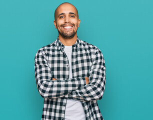 Hispanic adult man wearing casual clothes happy face smiling with crossed arms looking at the camera. positive person.